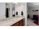 Bathroom boasts double sinks, granite countertop, and views to a bedroom with a stylish world map wall hanging at 2260 Grayling St, Orlando, FL 32820