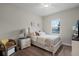 This cozy bedroom offers a soft bed, a side table with lamp, and window bringing in natural light at 2260 Grayling St, Orlando, FL 32820