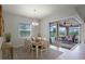 Comfortable dining room with sliding glass doors that open to the screened-in lanai and backyard views at 2260 Grayling St, Orlando, FL 32820