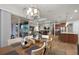 Dining area with modern chandelier, view of the backyard, and seamless flow to the living areas at 2260 Grayling St, Orlando, FL 32820