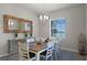 Inviting dining room with wood-look mirror and access to outdoor views through the window at 2260 Grayling St, Orlando, FL 32820