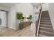 Grand foyer featuring a staircase, tall ceilings, stylish decor, and elegant wood-look tile flooring at 2260 Grayling St, Orlando, FL 32820