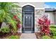 Close-up of the ornate front door with stone accents and decorative landscaping at 2260 Grayling St, Orlando, FL 32820