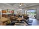 Bright open-concept living room with adjacent kitchen, and screened lanai access, perfect for entertaining at 2260 Grayling St, Orlando, FL 32820