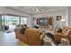 Stylish living room with a screen lanai view, featuring an entertainment center, and leather furniture at 2260 Grayling St, Orlando, FL 32820
