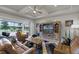 Living room showcasing a coffered ceiling, a TV, a leather sofa, and a screened lanai at 2260 Grayling St, Orlando, FL 32820
