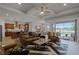Spacious living room with an open floor plan, opening to a screened lanai, kitchen, and dining area at 2260 Grayling St, Orlando, FL 32820