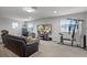 Spacious living room features plush seating, a flat-screen TV, and a home gym setup at 2260 Grayling St, Orlando, FL 32820