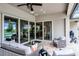 Covered patio with comfortable seating and view through sliding glass doors to the living room and kitchen at 2260 Grayling St, Orlando, FL 32820
