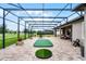 Large screened patio with a putting green, seating area, and relaxing outdoor space at 2260 Grayling St, Orlando, FL 32820