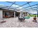 Spacious screened-in patio with outdoor seating, putting green, and tranquil views at 2260 Grayling St, Orlando, FL 32820