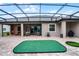 Expansive screened lanai with outdoor seating, putting green, and covered area at 2260 Grayling St, Orlando, FL 32820