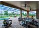 Relaxing screened patio with comfortable seating, ceiling fans, and a putting green at 2260 Grayling St, Orlando, FL 32820