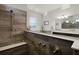 Bathroom shower features wood-style tiling, a built-in bench, and sleek bronze hardware at 2260 Grayling St, Orlando, FL 32820