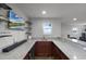 Stylish wet bar features granite countertops, custom cabinets, a beverage cooler, and display shelving at 2260 Grayling St, Orlando, FL 32820