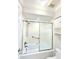 Clean bathroom with tub and shower combination featuring a sliding glass door at 2316 E Margarita Ct, Kissimmee, FL 34741