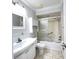 Bright bathroom with a large vanity, toilet, and shower tub with sliding door at 2316 E Margarita Ct, Kissimmee, FL 34741