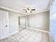 Cozy bedroom featuring a ceiling fan and a closet with mirrored doors at 2316 E Margarita Ct, Kissimmee, FL 34741