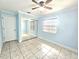 Sunlit bedroom with tile floors, ceiling fan, and large mirrored closet at 2316 E Margarita Ct, Kissimmee, FL 34741
