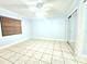 Bright bedroom with ceiling fan, tile flooring, and mirrored closet at 2316 E Margarita Ct, Kissimmee, FL 34741