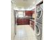 Renovated kitchen featuring stainless steel appliances, granite countertops, dark cabinets, and in-unit laundry access at 2316 E Margarita Ct, Kissimmee, FL 34741