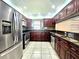A beautifully renovated kitchen featuring new stainless steel appliances and dark wood cabinets at 2316 E Margarita Ct, Kissimmee, FL 34741