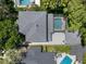 Aerial view of a home with a screened-in pool nestled among lush greenery and neighboring houses at 2339 Lafayette Ave, Winter Park, FL 32789