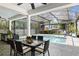 Inviting screened-in lanai with dining table overlooking a pool and backyard at 2339 Lafayette Ave, Winter Park, FL 32789