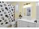 Bathroom featuring a white vanity, decorative mirror, and a shower with a patterned curtain at 2339 Lafayette Ave, Winter Park, FL 32789