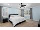 Bedroom with light blue walls, white shutters and a ceiling fan at 2339 Lafayette Ave, Winter Park, FL 32789