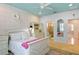 Stylishly decorated bedroom with a teal ceiling, white furniture, and patterned wallpaper at 2339 Lafayette Ave, Winter Park, FL 32789
