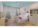 Bright bedroom with a white bed, pink accents, ceiling fan, and decorative wallpaper at 2339 Lafayette Ave, Winter Park, FL 32789