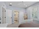 Comfortable bedroom with an attached bathroom, plantation shutters, and a ceiling fan at 2339 Lafayette Ave, Winter Park, FL 32789
