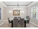 Dining room features a glass-top table, seating for six, and bright light from a window with shutters at 2339 Lafayette Ave, Winter Park, FL 32789