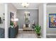 A neutral toned foyer with decorative plants and elegant decor and hardwood style floors at 2339 Lafayette Ave, Winter Park, FL 32789