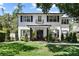Stunning two-story home with black shutters, a lovely lawn, and well manicured landscaping at 2339 Lafayette Ave, Winter Park, FL 32789