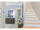 A bright foyer featuring a staircase, stylish decor, and modern accents that welcome you into the home at 2339 Lafayette Ave, Winter Park, FL 32789