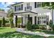 Inviting front porch with seating area, stylish black accents, and lush landscaping at 2339 Lafayette Ave, Winter Park, FL 32789