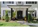 Welcoming front entrance featuring a covered porch with stylish seating and well-manicured landscaping at 2339 Lafayette Ave, Winter Park, FL 32789