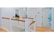 Hallway with wood floors and white trim leading to multiple rooms at 2339 Lafayette Ave, Winter Park, FL 32789