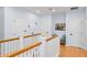 Upstairs hallway features wood floors and a view of multiple bedrooms at 2339 Lafayette Ave, Winter Park, FL 32789