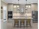 Modern kitchen featuring a large island, stainless steel appliances, and elegant pendant lighting at 2339 Lafayette Ave, Winter Park, FL 32789