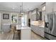 Modern kitchen with stainless steel appliances, grey cabinetry, island with sink and stylish light fixture at 2339 Lafayette Ave, Winter Park, FL 32789