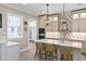 Open-concept kitchen with island, seating, stainless appliances, and stylish light fixtures at 2339 Lafayette Ave, Winter Park, FL 32789