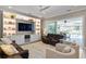 Comfortable living room features built-in shelving, recessed lighting, and seamless access to an outdoor pool at 2339 Lafayette Ave, Winter Park, FL 32789