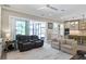 Open floorplan living room with a partial view of kitchen and a sliding glass door to the backyard at 2339 Lafayette Ave, Winter Park, FL 32789