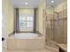Luxurious main bathroom featuring a garden tub and walk in shower at 2339 Lafayette Ave, Winter Park, FL 32789