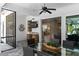 Inviting covered outdoor space, featuring a large-screen TV, ceiling fan, and stylish furniture with a serene backyard view at 2339 Lafayette Ave, Winter Park, FL 32789