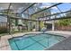 Enjoy the refreshing screened-in pool with a basketball hoop and a spacious backyard area at 2339 Lafayette Ave, Winter Park, FL 32789