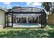 A screened-in pool with an outdoor kitchen and bar area is perfect for relaxing and entertaining at 2339 Lafayette Ave, Winter Park, FL 32789